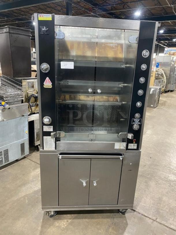 Rotisol commercial stainless steel rotisserie oven, model 9505, with tempered glass doors, enclosed cabinet base, and retractable workstation on casters.