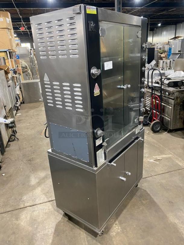 Rotisol Model 9505 stainless steel rotisserie oven, natural gas powered, with tempered glass doors, enclosed cabinet base, workstation, on casters.