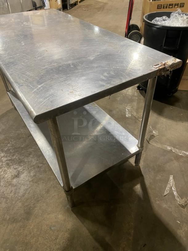 Sapphire stainless steel worktop table with undershelf, on legs. Scratches visible; ideal for commercial use.