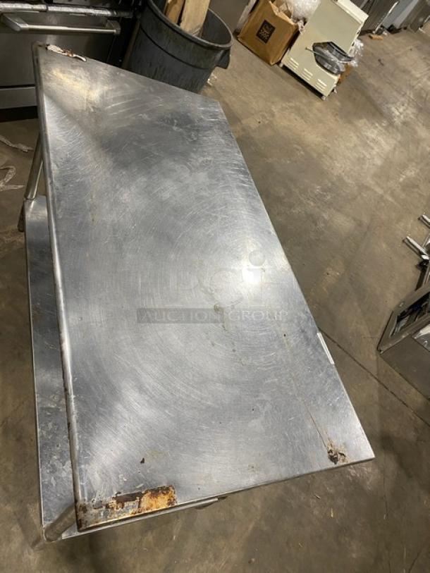 Sapphire stainless steel worktop table with single undershelf and legs, commercial grade, visible wear and rust on surface edges.