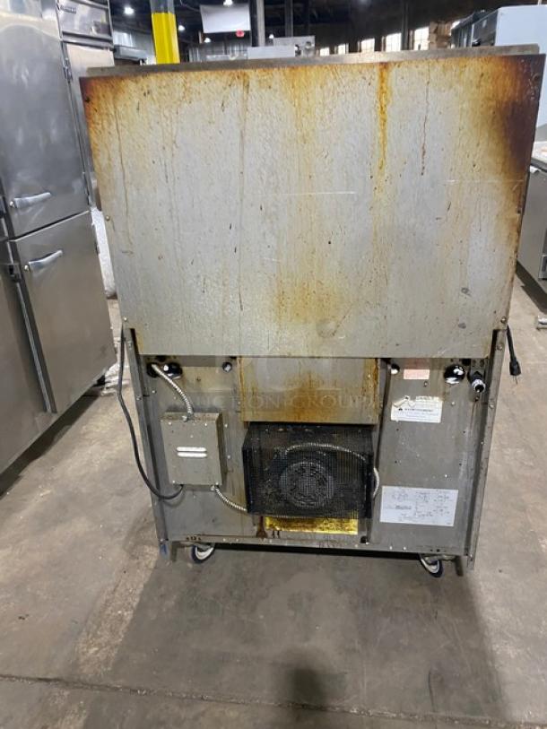 Garland G36-6C stainless steel 6-burner gas range/oven. Includes backsplash, salamander shelf, wired oven rack. On casters.