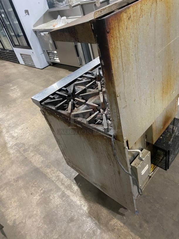 Garland G366C commercial stainless steel 6-burner gas range/oven combo, with backsplash, salamander shelf, and wired oven rack.