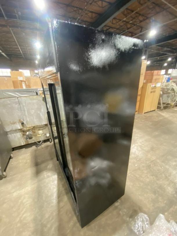 True Commercial Black Double Glass Sliding Door Reach-In Merchandiser Refrigerator, Model GDM-45EM-LD, in used condition.