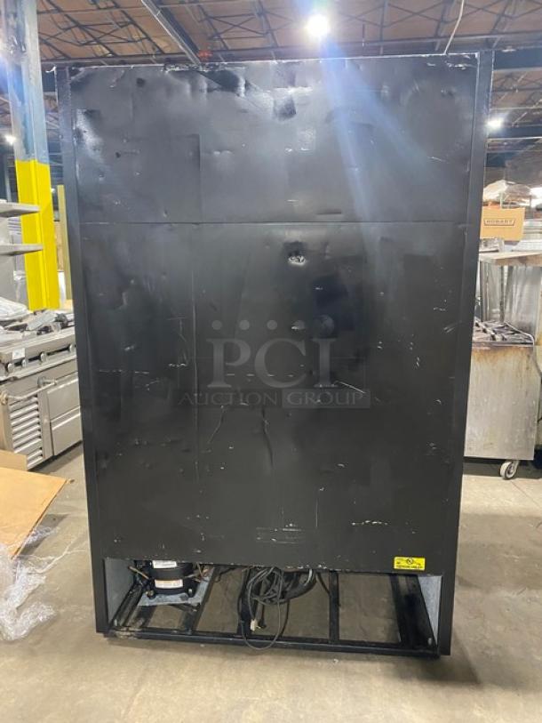 True GDM-45EM-LD commercial black double glass sliding door refrigerator back view, visible wiring and compressor.