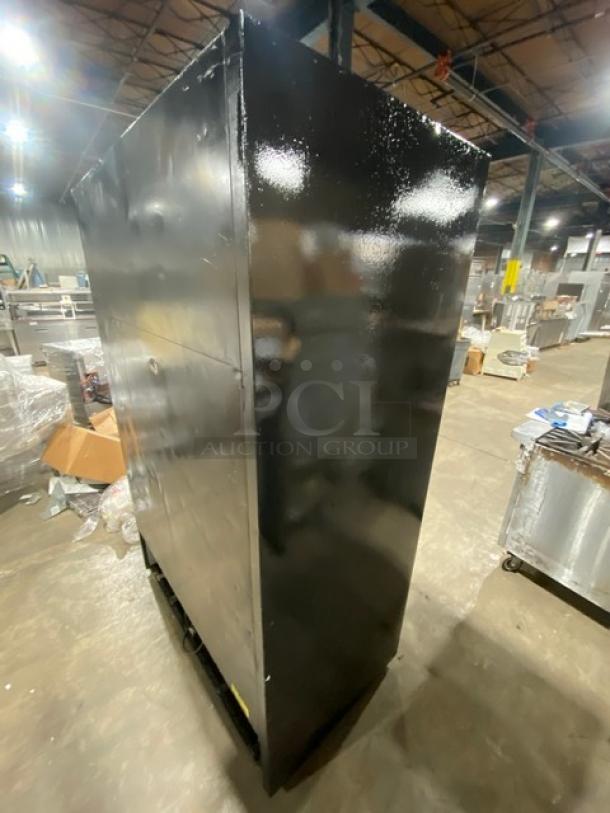 True GDM-45EM-LD commercial refrigerator, black, double glass sliding door, poly coated wired rack, side view.