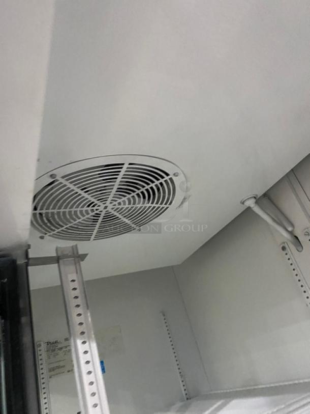 True Commercial Refrigerator, model GDM-45EM-LD, interior view. Features sliding glass doors and a poly-coated wire rack.