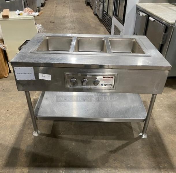 Wells MOD300TDM 3-well hot food table, stainless steel, electric, thermostatic controls, single undershelf, on legs.