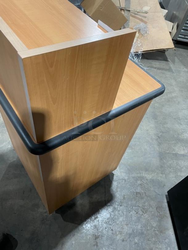 Commercial wooden recycle-style trash receptacle cabinet with upper serving tray storage and legs.