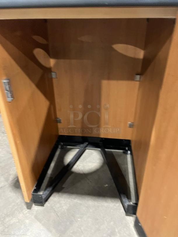 Commercial wooden trash receptacle cabinet, recycle-style, with upper serving tray storage and legs.