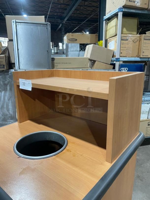 Commercial wooden waste receptacle cabinet with recycle-style opening, upper serving tray storage, and leg supports.