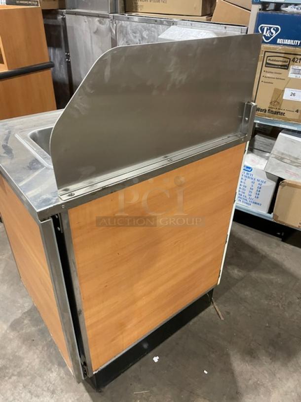 Duke stainless steel hand washing cabinet, model SUB-PS-24-C M, with back and right-side splash, wood paneling, used condition.