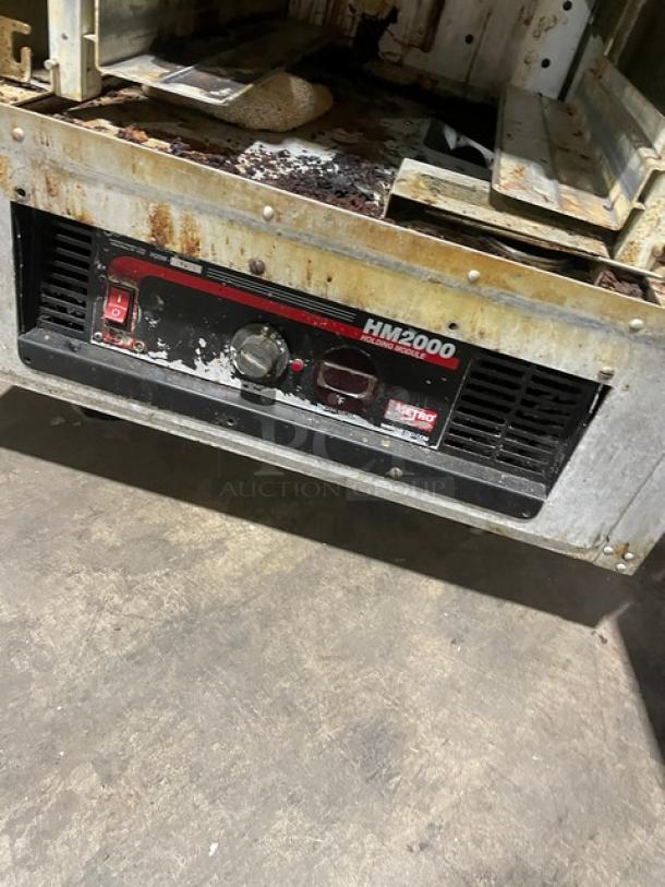 Metro Flavor Hold Series heated cabinet, Model C199H1N, with pan slides and casters. Shows wear and rust on base.