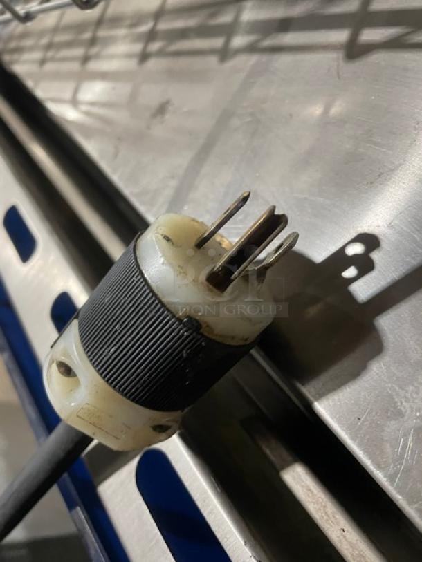 Close-up of a power plug for Metro C199-H(1)N insulated mobile heated cabinet, 120V, showing prongs and cable end.