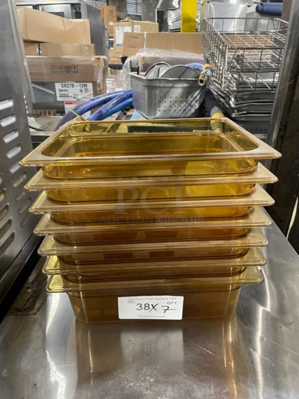 Rubbermaid Commercial Amber High Heat 1/2-Size 4" Deep Food Pans. Model FG224P00AMBR. New, stacked, auction label visible.