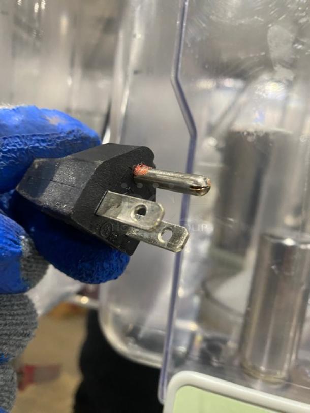 Coldline Royal-2P 120V refrigerated beverage dispenser power plug, with visible wear on plug tip. Polycarbonate hopper in the background.
