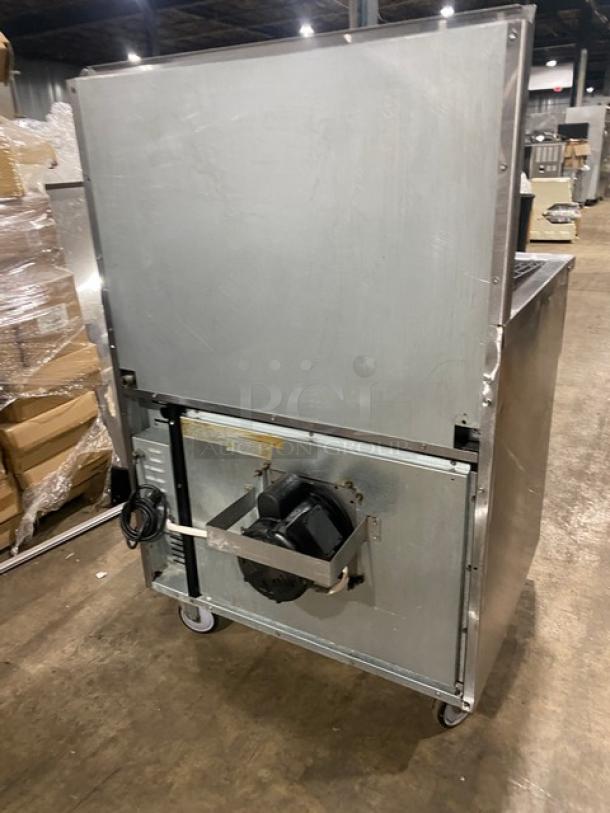 Imperial stainless steel gas char broiler range/oven combo with backsplash, wired oven rack, and casters. Commercial use.