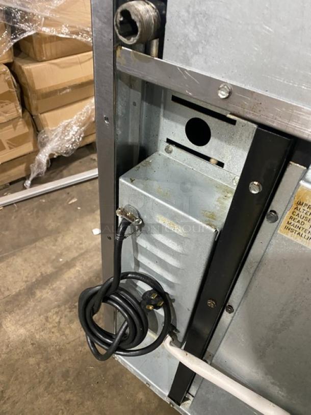 Imperial gas stainless steel char broiler back view with wiring and vent detail. Includes casters and attached power cord.