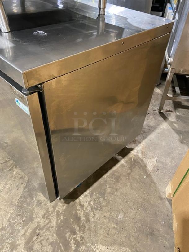 Commercial stainless steel 2-door refrigerated lowboy worktop cooler with poly coated wired rack and casters.