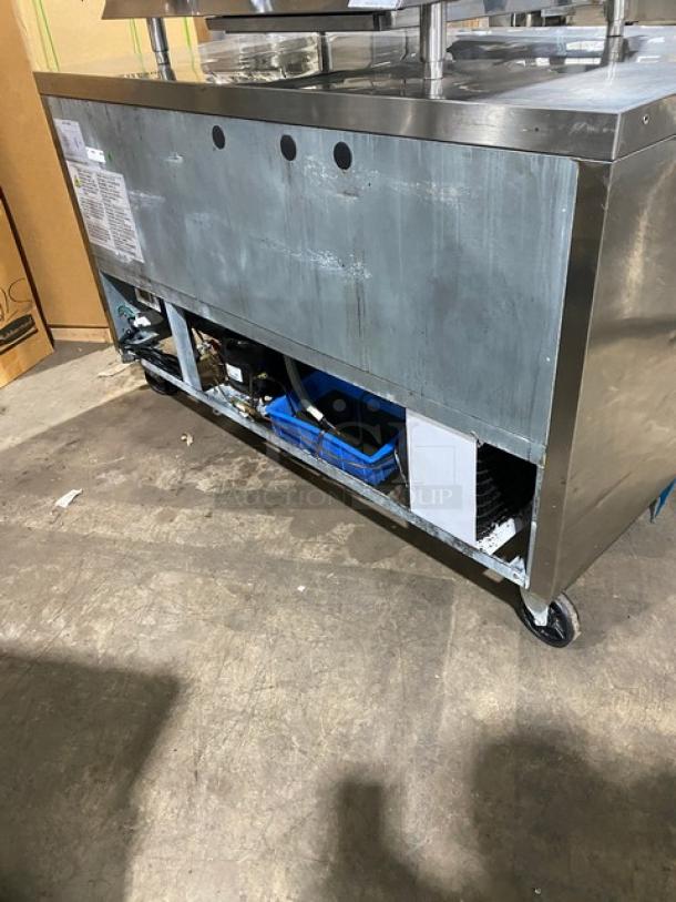 Commercial stainless steel 2-door refrigerated lowboy worktop cooler with poly-coated wired rack, on casters, visible markings.