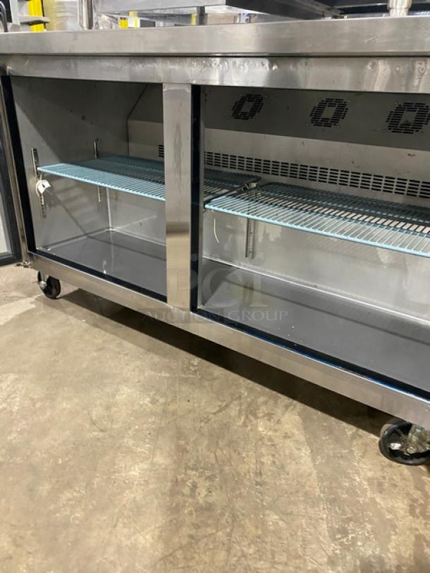 Commercial stainless steel 2-door lowboy cooler, poly coated wired rack, on casters. Ideal for professional kitchens.