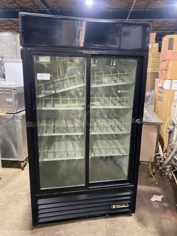 True GDM-37 commercial black double glass sliding door refrigerator with poly-coated wired rack, model GDM37, SN: 1-4253731, in used condition.