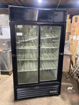 True GDM-37 commercial black double glass sliding door refrigerator with poly-coated wired rack, model GDM37, SN: 1-4253731, in used condition.