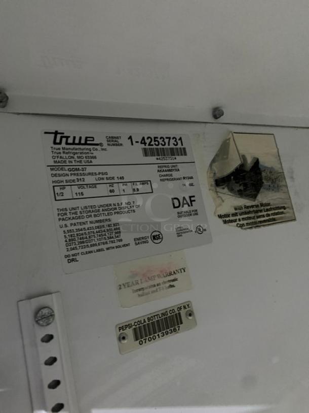 True GDM-37 merchandiser refrigerator label showing model number, serial number, and specifications.