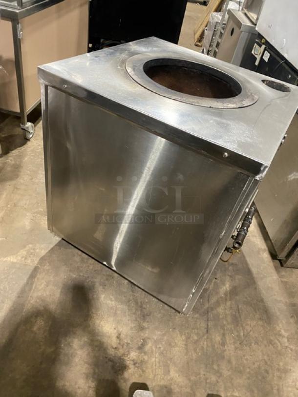 Commercial stainless steel natural gas tandoor oven on casters, showing wear. Ideal for busy kitchens.