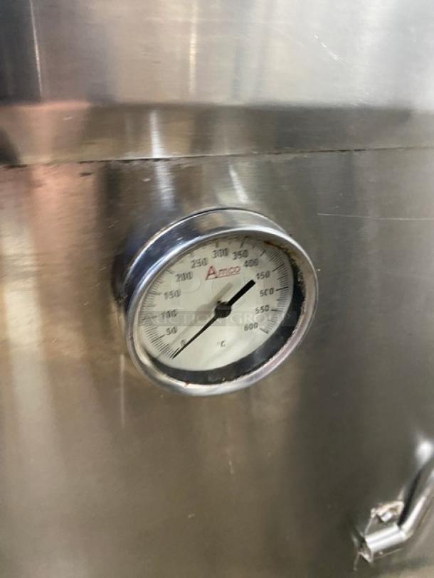 Commercial stainless steel natural gas tandoor oven with thermometer gauge. Features casters for mobility.