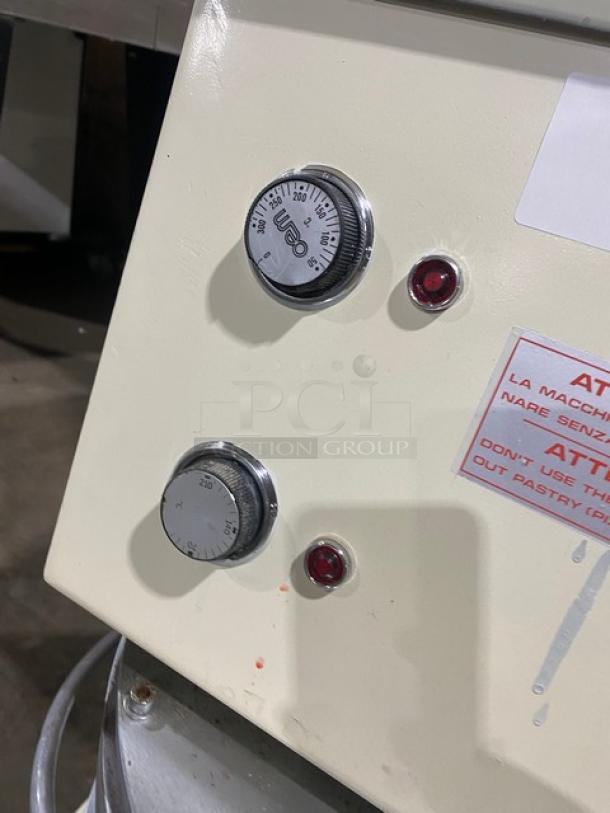 Morello Commercial White Electric Pizza Dough Press, featuring control knobs and warning label, mounted on legs.