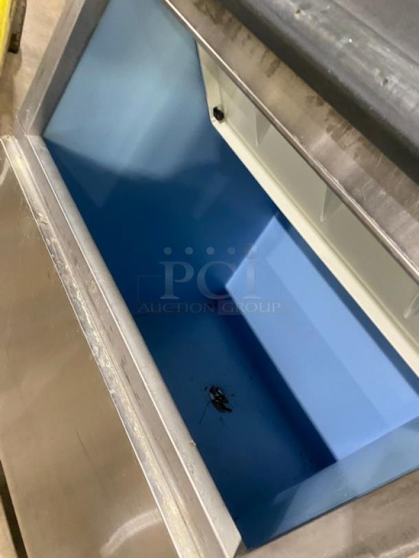 Ice-O-Matic ICE1006HA4 commercial ice machine, stainless steel, air-cooled, half cube, electric, on legs, open bin view.