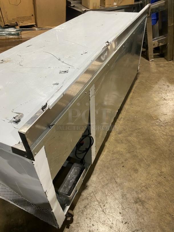 Custom Cool stainless steel 3-door refrigerated worktop table, model LB93, with up-turned backsplash, pan rack, on casters.