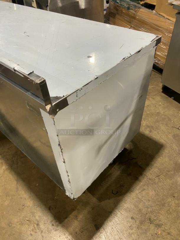 Custom Cool stainless steel 3-door refrigerated worktop table, model LB93, up-turned back splash, built-in pan rack, on casters.