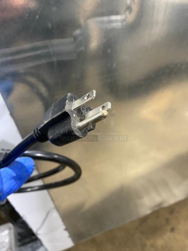 Close-up of a power plug with a three-prong connector for the Custom Cool LB93 refrigerated worktop table.