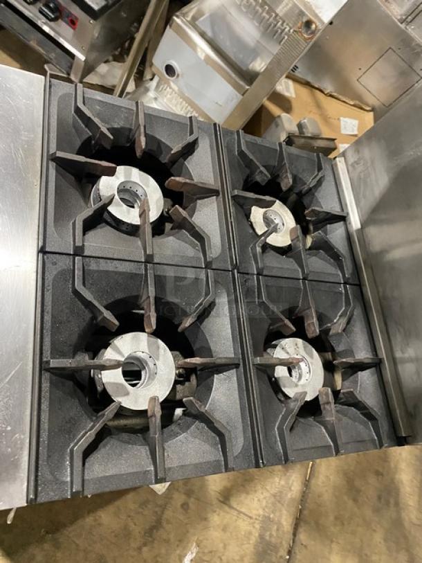 CookRite stainless steel 4-burner gas range with oven combo, backsplash, salamander shelf, and casters. Used condition.