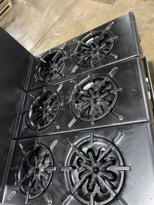 Garland commercial black 6-burner gas range with backsplash and overhead salamander shelf. Includes wired oven rack.