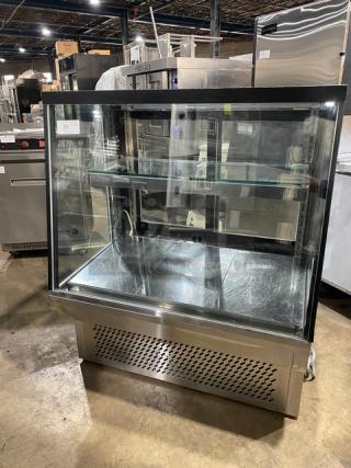 Commercial stainless steel bakery display case with slanted glass, multi-tier shelving, rear sliding glass doors, on legs.