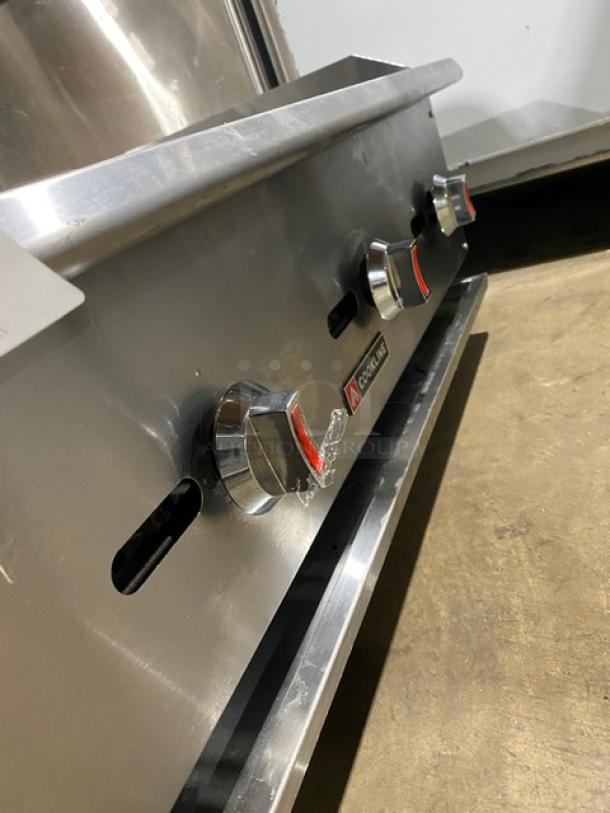 Cookline 60" stainless steel gas char broiler, features heavy-duty radiant cooking surface, three control knobs, on legs, excellent condition.