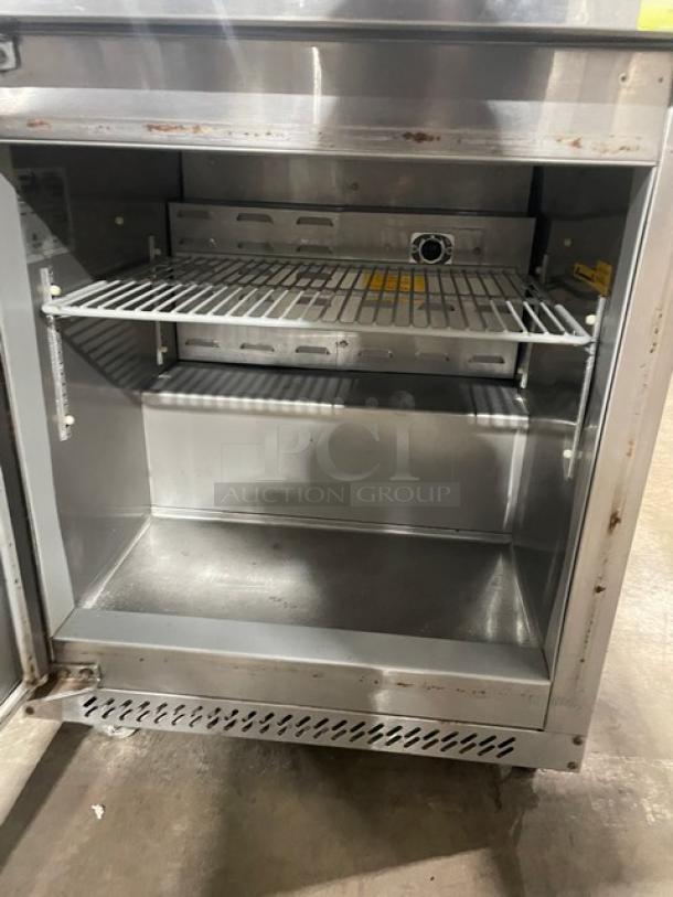 Fagor FUR-27 stainless steel undercounter refrigerator with poly coated rack, single door, on casters, model SN: 07070051M.