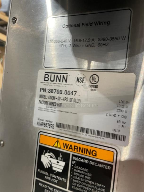 Bunn AXIOMDVAPS coffee brewer label, showing model, serial number AXAP007876, voltage, and warning instructions.