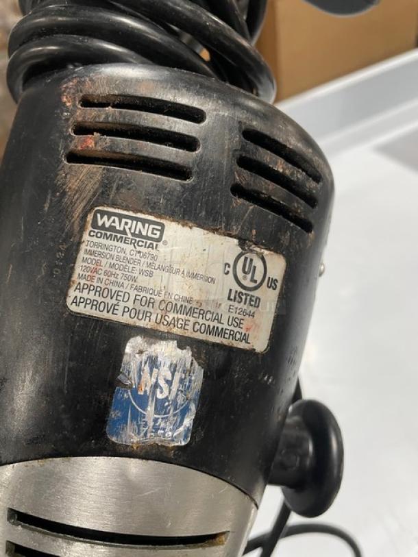 Waring Commercial WSB Immersion Blender, Model 120V, shows wear; labels indicate UL and NSF certification, for commercial use.