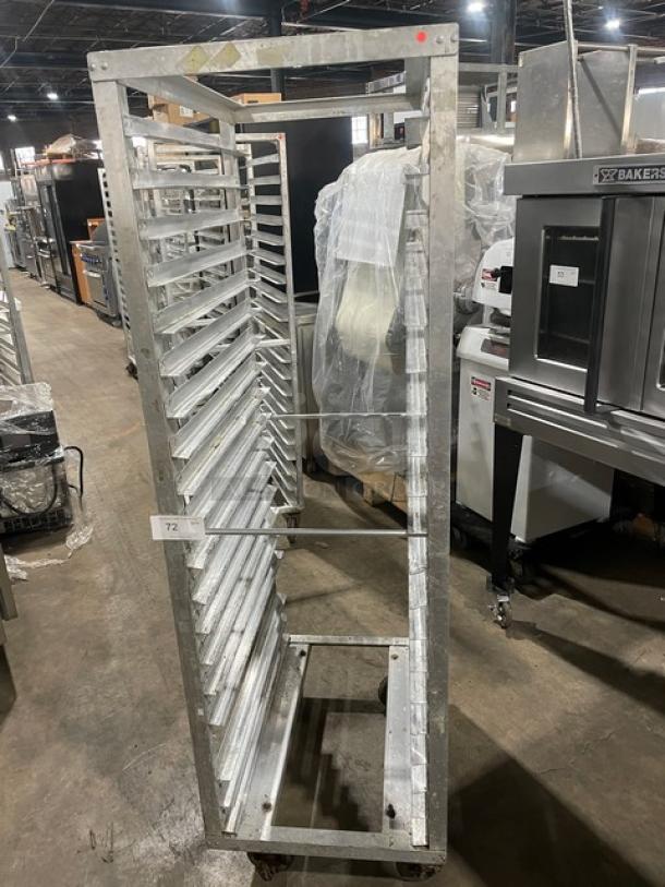 Commercial aluminum 20-pan end-load sheet pan holding rack in used condition, featuring caster wheels for transport.