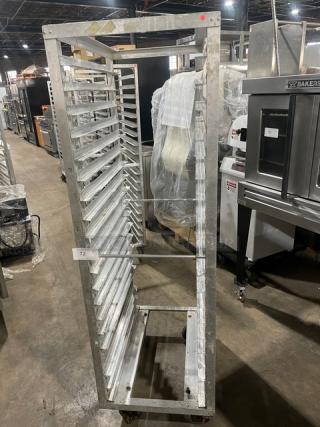 Commercial aluminum 20-pan end-load sheet pan holding rack in used condition, featuring caster wheels for transport.