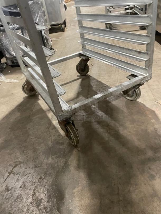Commercial aluminum 20-pan end-load rack with wheels, holds sheet pans, used condition, ideal for transport and storage.