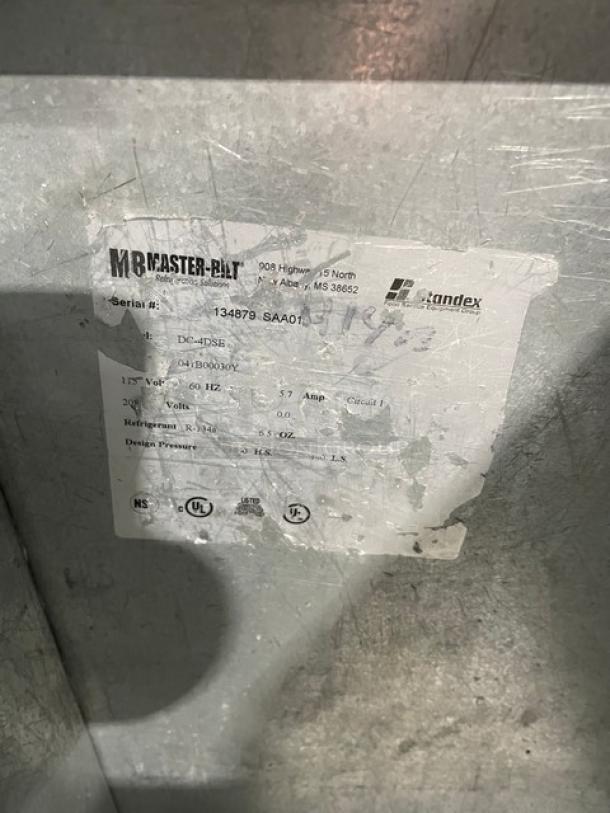 Master-Bilt stainless steel ice cream dipping cabinet, model DC-4DSE, with flip lid, poly-coated rack, and visible model label.