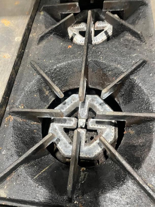 US Range commercial 2-burner natural gas griddle range, steel construction, visible wear, part of auction image.