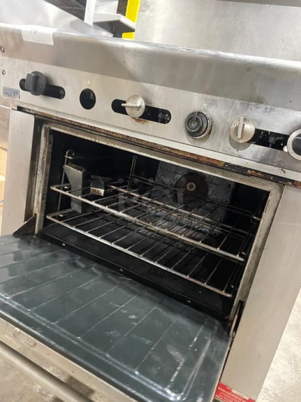 US Range commercial stainless steel 2-burner griddle range/oven combo on casters, with overhead salamander shelf, wired oven rack.