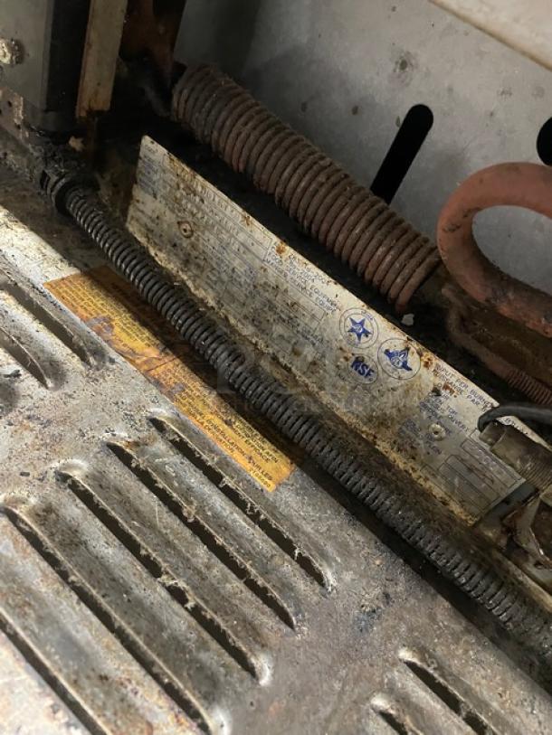 US Range stainless steel 2-burner flat griddle range/oven combo, natural gas, with backsplash, overhead salamander shelf, and casters.