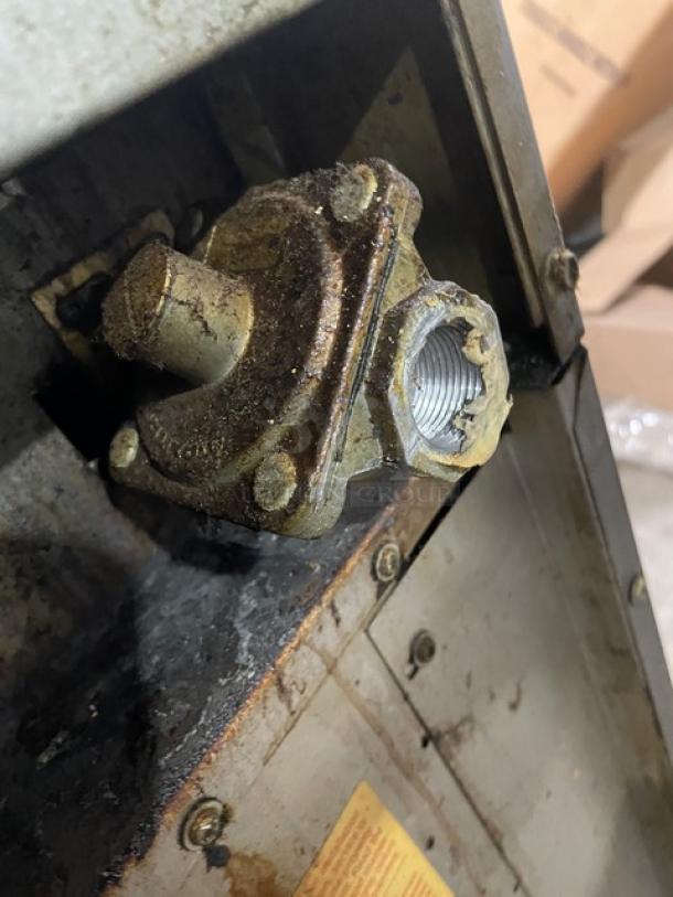 US Range stainless steel commercial gas range/oven combo with 2-burner split-top, flat griddle, backsplash, salamander shelf, and wired oven rack on casters.