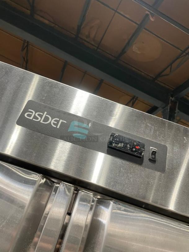 Asber APR49HF stainless steel 2-door reach-in refrigerator. Features poly coated wired rack and control panel. In good condition.